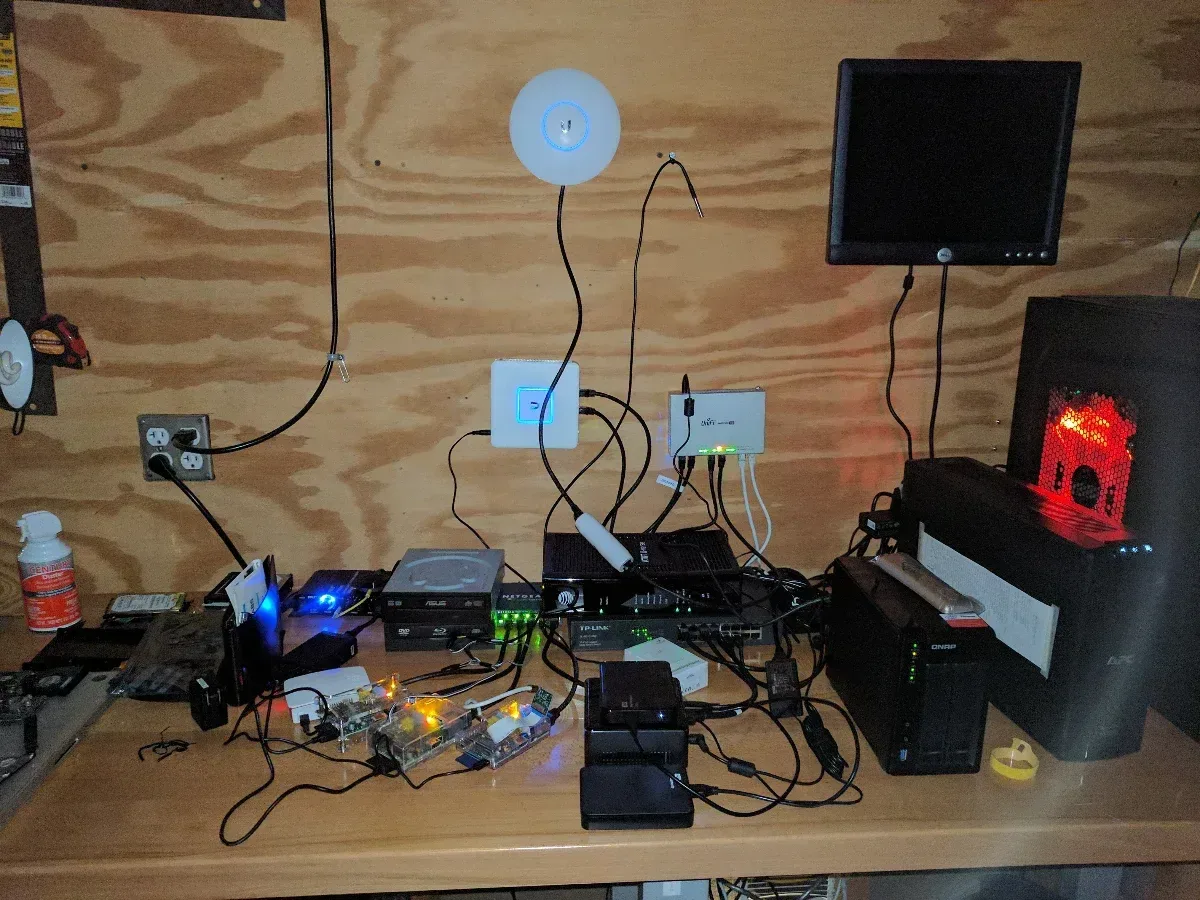 Expanded shelf setup with an access point, monitor, small computers, and additional wiring.