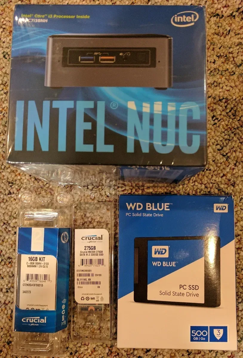 Boxed Intel NUC and WD Blue storage drives ready for installation.