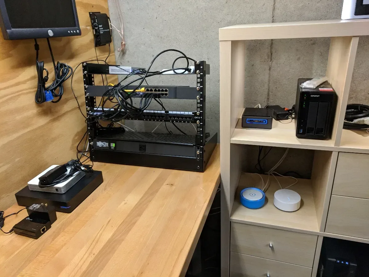 Network rack and tower server installed beside a storage shelf.