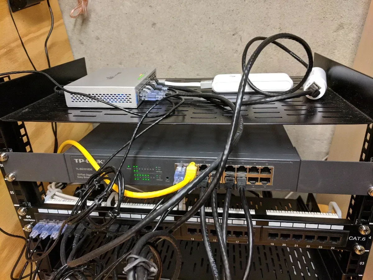 Close-up of cabling and equipment at the rear of the network rack.