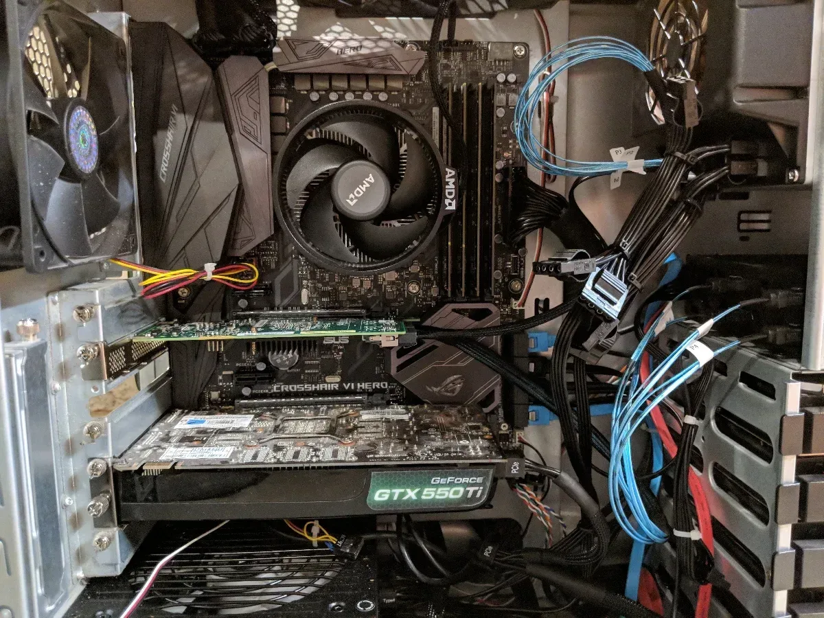 Inside the tower server showing the motherboard, cooling fan, expansion card, and drive cables.