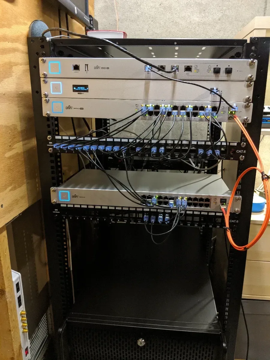 Mostly empty rack frame with patch panels mounted near the top.