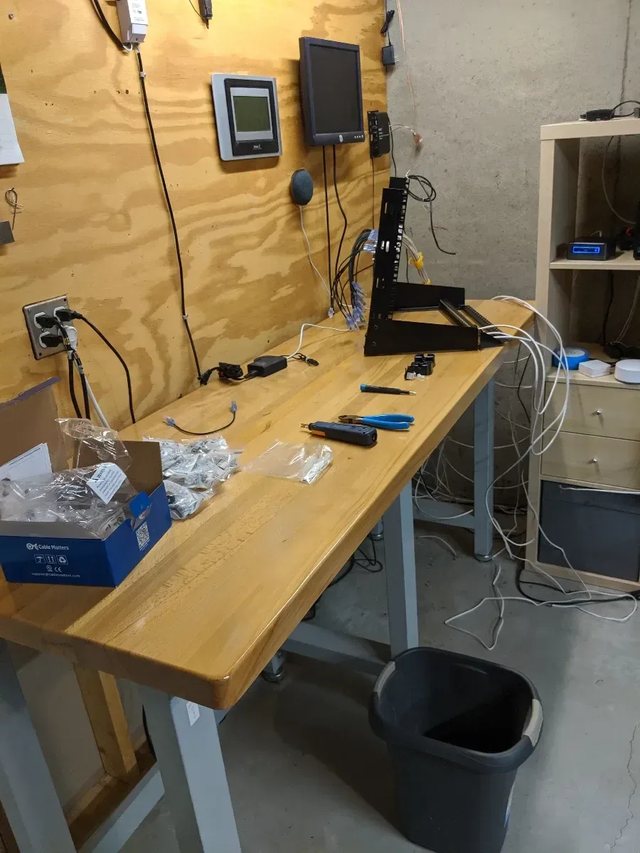 Cleared wooden workbench during a homelab rebuild.