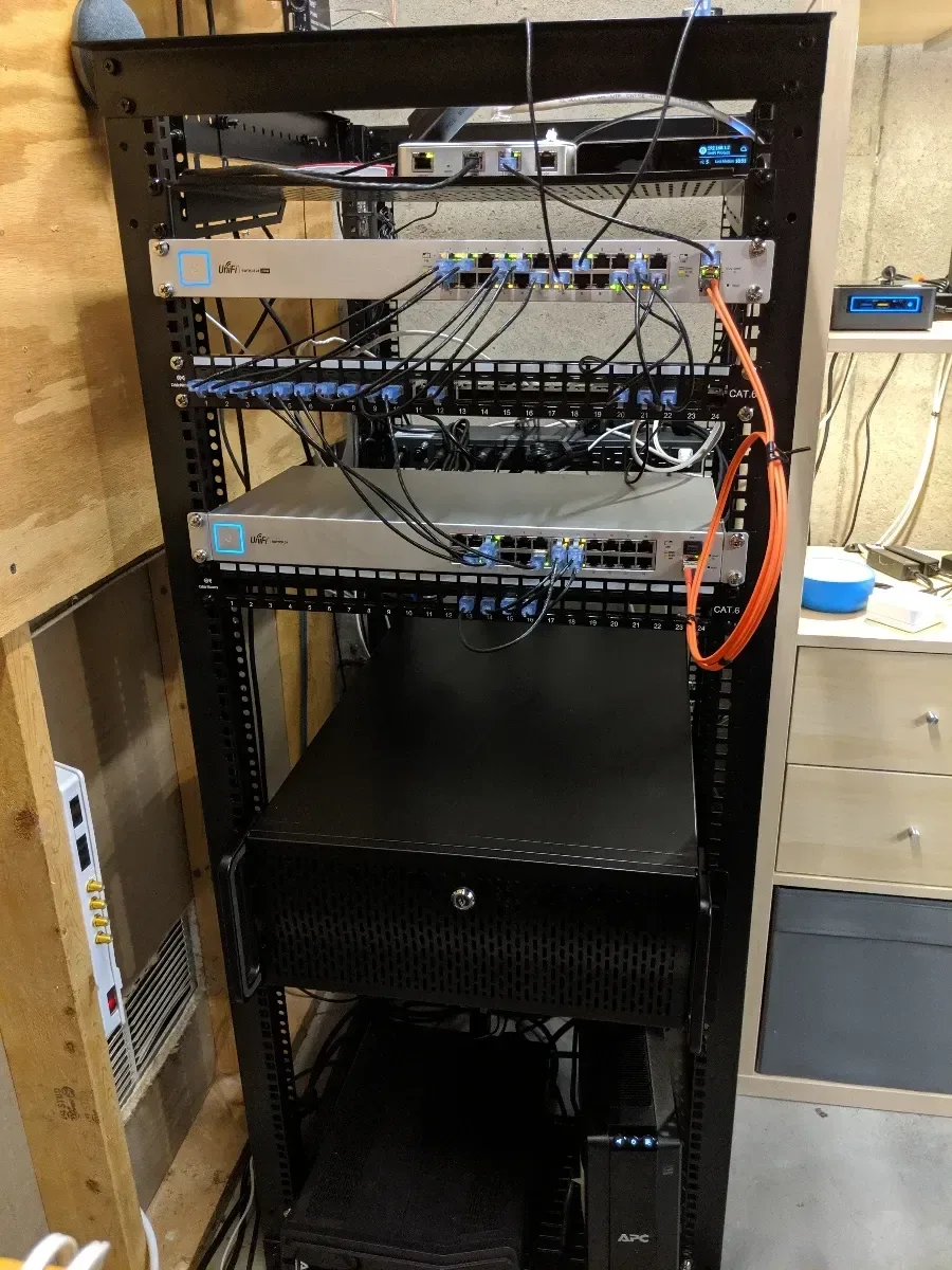Tall rack with patch panels, network equipment, and open space for expansion.