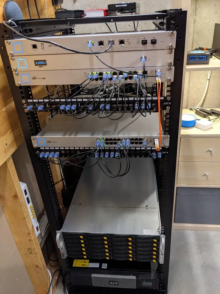 Network rack with patch panels, switches, and a storage server installed below.