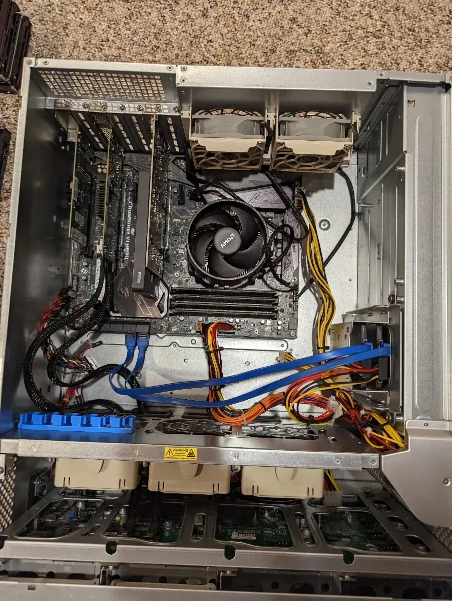 Open rackmount server showing internal fans, expansion cards, and cabling.
