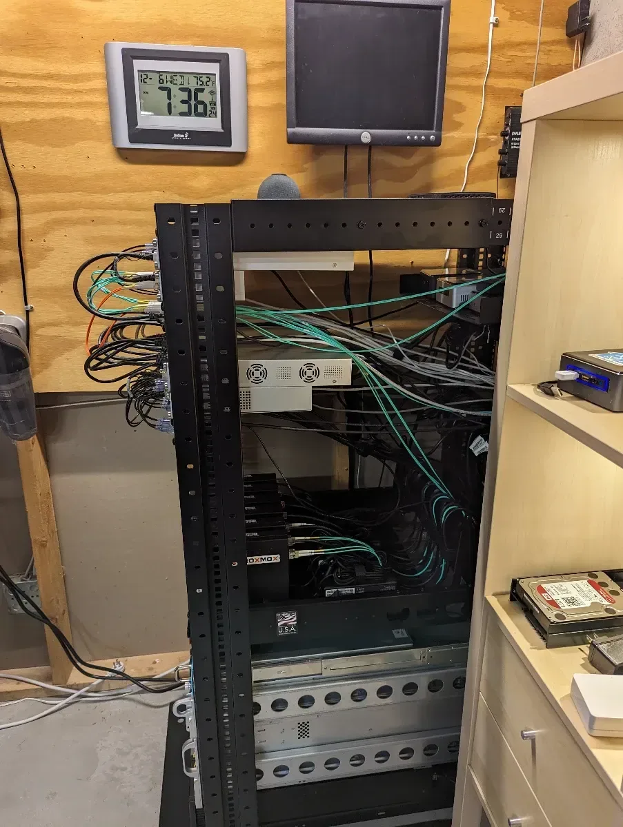 Network rack with switches, patch panels, and open lower bays before the next expansion.