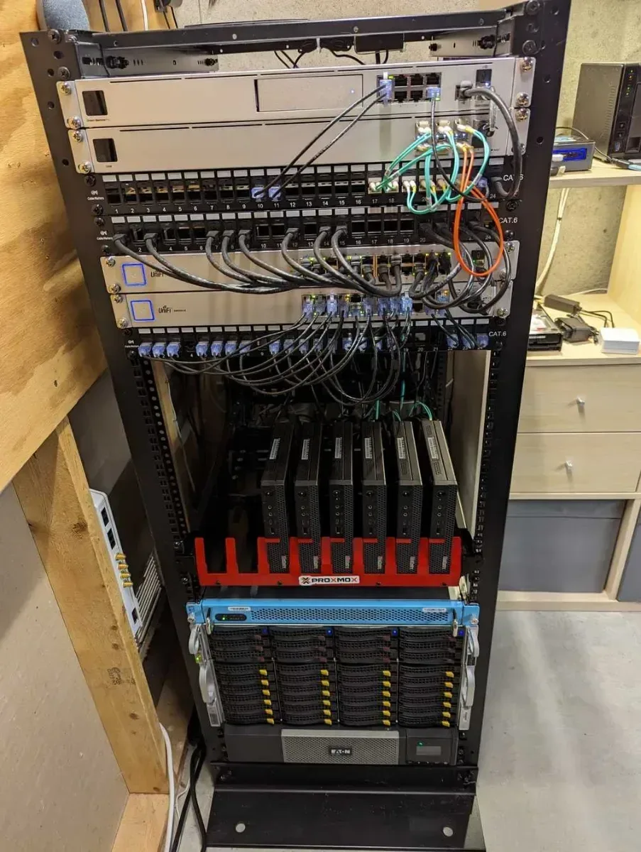 Full rack with network gear, a mini PC cluster, and storage arrays.