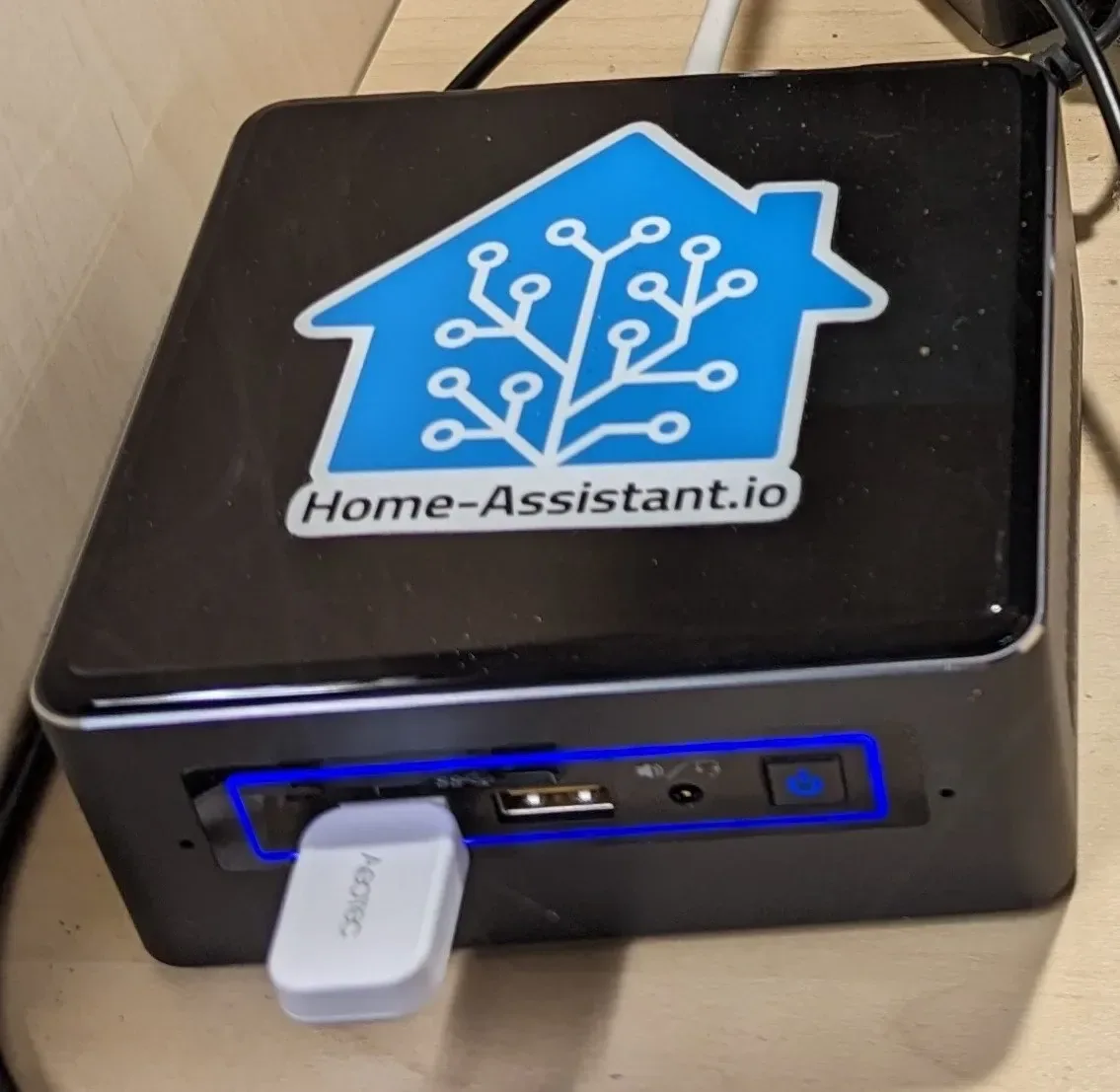 Intel NUC with a Home Assistant logo sticker on its lid.
